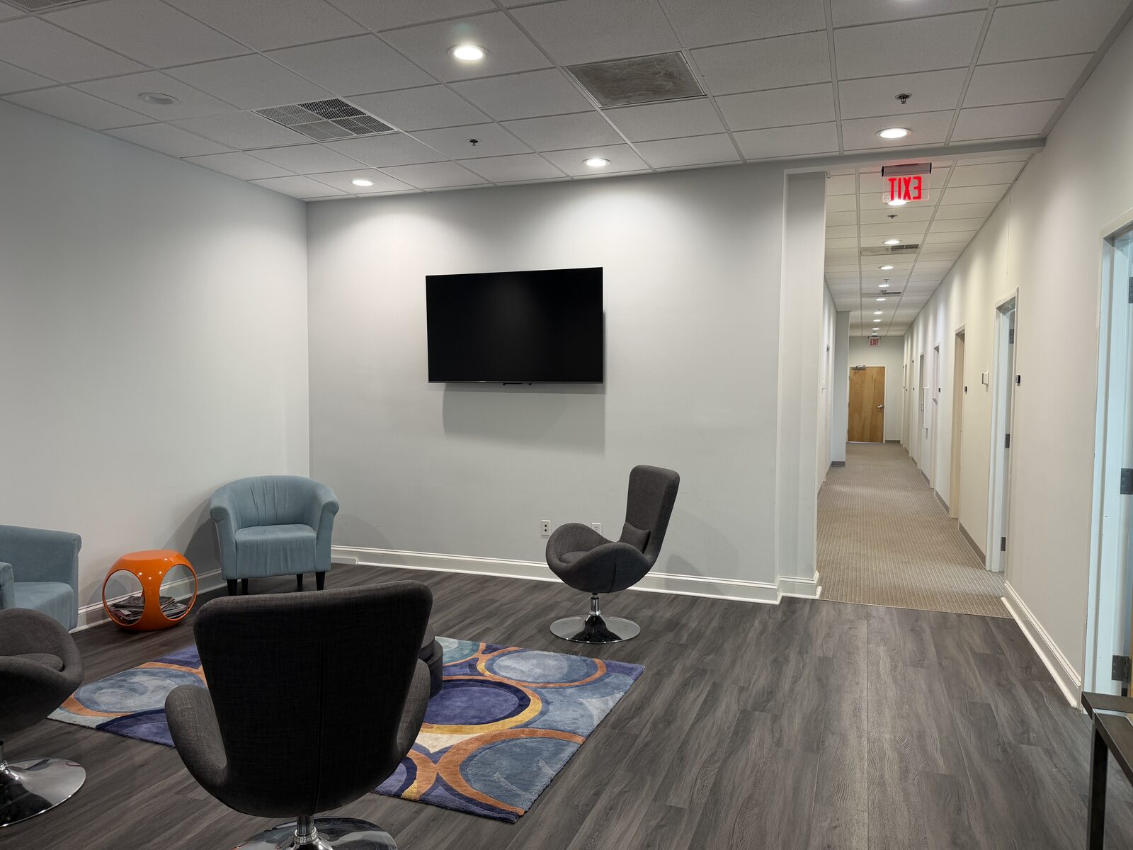 Clean office hallway with private executive offices on either side